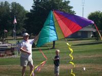 Plainville back pain free grandpa and grandson playing with a kite